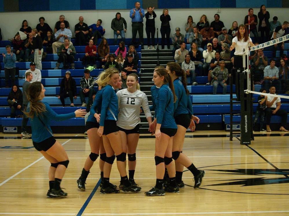 The Falcons celebrate the first playoff victory in the history of Women's Volleyball at FLC.